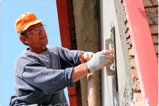 Plasterer smoothing out a wall surface